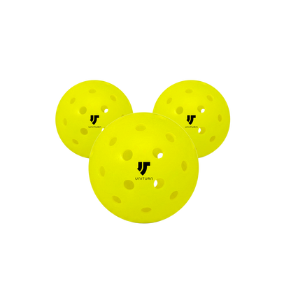 Three yellow pickleballs with a black logo on a white background